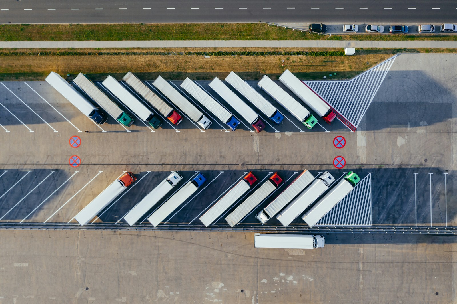 Aerial view of storage trailers parked in marked rows at a fenced industrial yard, the kind of organized visible placement that deters trailer theft