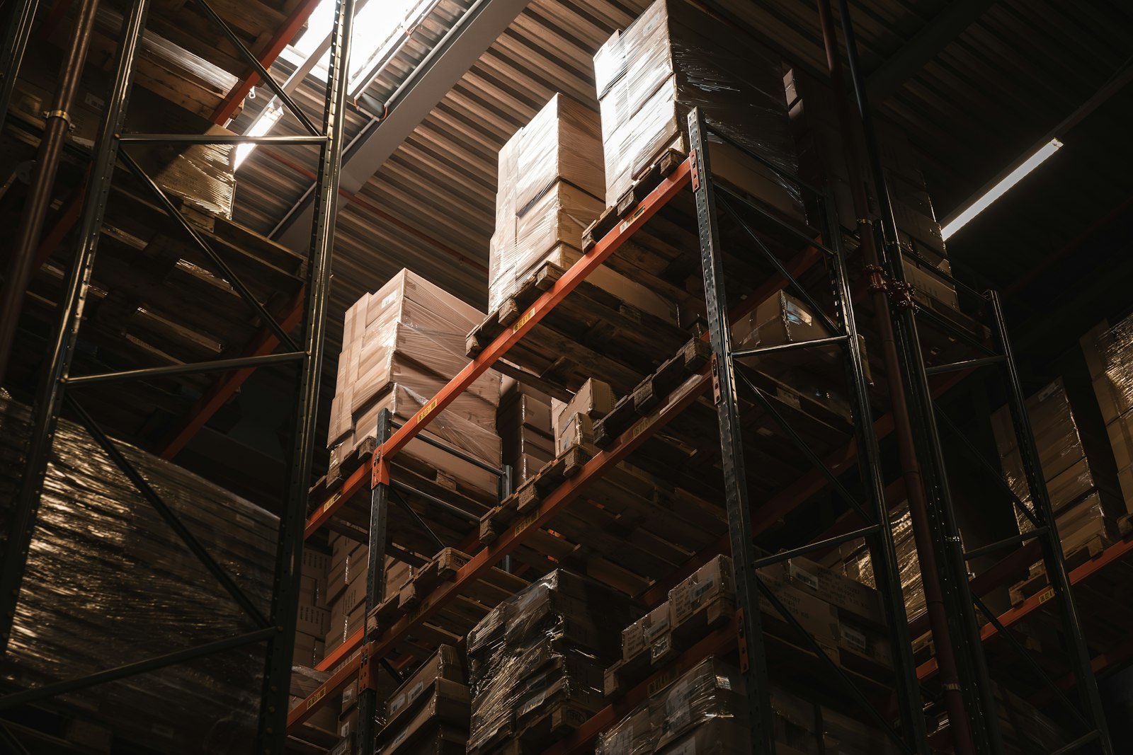Warehouse racking loaded to the roof with boxed pallets, the point where a dock-height storage trailer from RMA Fleet becomes a warehouse on wheels for overflow inventory